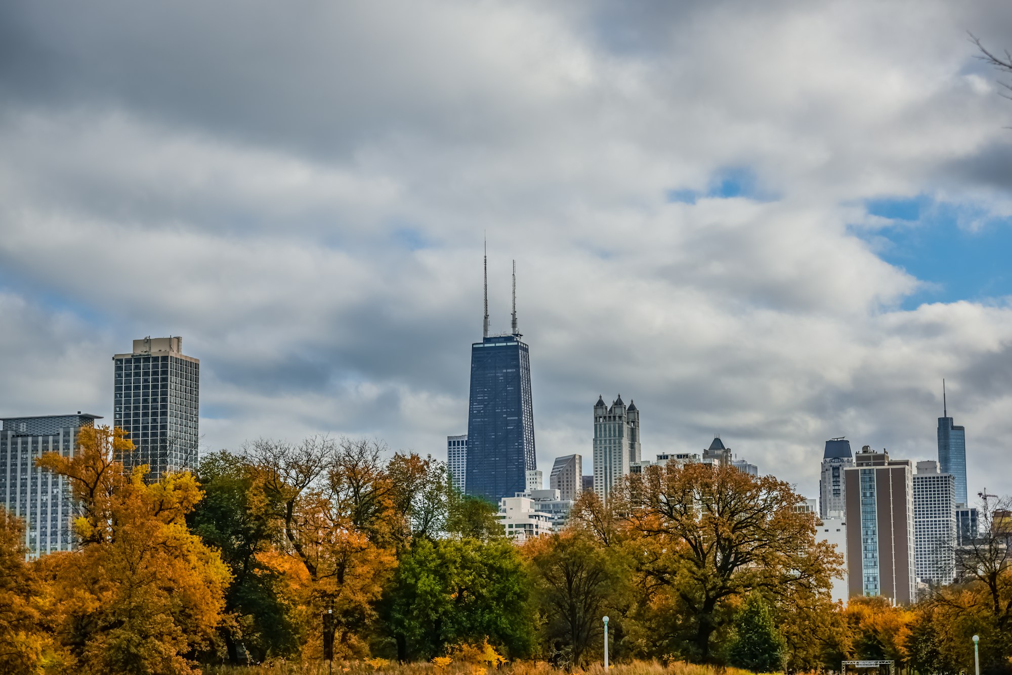 Golden autumn trees in Lincoln Park with Chicago’s skyline and the John Hancock Center beyond